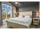 This bedroom features a ceiling fan, large window with a view, and grey accent wall at 16118 Peregrine Dr, Parker, CO 80134