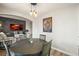 Open layout dining room with modern lighting, table seating and view into living area at 16118 Peregrine Dr, Parker, CO 80134