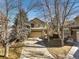 Traditional style home with a large driveway and mature trees adding curb appeal at 16118 Peregrine Dr, Parker, CO 80134