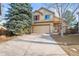 Attractive front exterior with a two-car garage, red shutters and a well-manicured lawn at 16118 Peregrine Dr, Parker, CO 80134