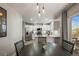 Well-lit eat-in kitchen featuring granite countertops, stainless appliances, and modern pendant lighting at 16118 Peregrine Dr, Parker, CO 80134