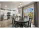 Eat-in kitchen with stainless appliances, pendant lighting, and sliding glass doors to the deck at 16118 Peregrine Dr, Parker, CO 80134