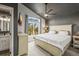 Bright main bedroom featuring a large arched window and ensuite bathroom at 16118 Peregrine Dr, Parker, CO 80134