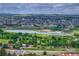 An aerial view of the neighborhood with houses, lake, and green spaces at 11837 Meadowood Ln, Parker, CO 80138