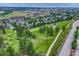 An aerial view of a neighborhood highlighting tree-lined streets, green spaces, and residential homes at 11837 Meadowood Ln, Parker, CO 80138