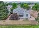 The backyard has a wooden fence, rock landscaping, bay window, and is adjacent to a walking path at 11837 Meadowood Ln, Parker, CO 80138