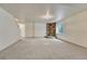 Spacious finished basement area with stone accent wall, and neutral carpet at 11837 Meadowood Ln, Parker, CO 80138