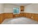 Carpeted basement space featuring paneling, a window, and a built in cabinet at 11837 Meadowood Ln, Parker, CO 80138