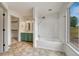 Bathroom features a bathtub, shower, and double sinks with stylish vanity at 11837 Meadowood Ln, Parker, CO 80138