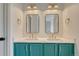 Bright bathroom with double sink, vanity and attractive teal cabinetry at 11837 Meadowood Ln, Parker, CO 80138