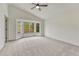 Bright bedroom features a ceiling fan, neutral carpet, and a bay window with a view at 11837 Meadowood Ln, Parker, CO 80138