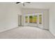 Comfortable bedroom features neutral carpet, a ceiling fan, and a bay window at 11837 Meadowood Ln, Parker, CO 80138