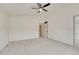 Large bedroom features a ceiling fan, neutral carpet, and white walls at 11837 Meadowood Ln, Parker, CO 80138