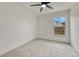 Cozy bedroom features a ceiling fan, neutral carpet, and a window with a view at 11837 Meadowood Ln, Parker, CO 80138