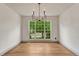 A bright dining room with hardwood floors, large window, and decorative chandelier at 11837 Meadowood Ln, Parker, CO 80138