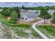 A partial aerial of the home's exterior showcasing a fenced yard and a paved walkway at 11837 Meadowood Ln, Parker, CO 80138