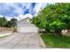 Exterior features a long paved driveway, lawn, and mature trees at 11837 Meadowood Ln, Parker, CO 80138