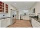 Kitchen includes stainless steel appliances, white cabinets, wood floors, and granite countertops at 11837 Meadowood Ln, Parker, CO 80138