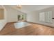 Bright living room boasts hardwood floors, a sliding door, and a modern light fixture at 11837 Meadowood Ln, Parker, CO 80138