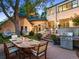 Large backyard perfect for entertaining, with an outdoor kitchen, dining area, and comfortable seating at 141 N Gilpin St, Denver, CO 80218