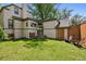 Spacious backyard with lush green lawn, patio, mature trees, and charming exterior at 141 N Gilpin St, Denver, CO 80218