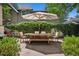 Backyard with patio, shade umbrella, and privacy hedge, perfect for outdoor gatherings at 141 N Gilpin St, Denver, CO 80218