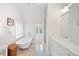 Well-lit bathroom features a soaking tub, marble counters, and a sleek, modern design at 141 N Gilpin St, Denver, CO 80218