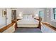 Comfortable bedroom boasts hardwood floors, side tables with lamps, and natural light at 141 N Gilpin St, Denver, CO 80218