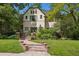 Charming home with a landscaped front yard, brick pathway, and beautiful curb appeal at 141 N Gilpin St, Denver, CO 80218