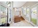 Foyer with stone tile, vintage wood cabinet, and sun-filled windows with transoms at 141 N Gilpin St, Denver, CO 80218