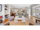 Open concept living room featuring hardwood floors, stylish furniture, and ample natural light at 141 N Gilpin St, Denver, CO 80218