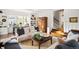 Bright living room boasts hardwood floors, white walls, and large windows that let in natural light at 141 N Gilpin St, Denver, CO 80218