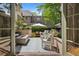 Charming outdoor patio with modern fire pit, ample seating, privacy landscaping, and cafe lighting at 141 N Gilpin St, Denver, CO 80218