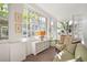Cozy sunroom featuring brick floors, lots of windows, and comfortable seating at 141 N Gilpin St, Denver, CO 80218