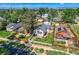 Charming home featuring a manicured lawn, complemented by mature trees and vibrant landscaping under a clear, sunny sky at 4883 Perry St, Denver, CO 80212