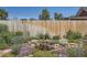 Backyard landscape featuring mature landscaping, including a rock-lined pond and colorful flowers at 4883 Perry St, Denver, CO 80212