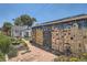 Backyard featuring a patio, lush greenery, and a colorful mural on the garage at 4883 Perry St, Denver, CO 80212