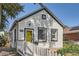 Charming home with a yellow front door, white siding, and a neatly maintained front yard at 4883 Perry St, Denver, CO 80212