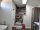 Modern bathroom featuring a custom tiled shower and wood-look tile flooring at 15460 Casler Ave, Fort Lupton, CO 80136