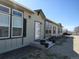 The exterior of the home features light-green siding, black trim, and well-manicured landscaping and a rock yard at 15460 Casler Ave, Fort Lupton, CO 80136