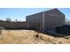 View of workshop building with an over-sized access door and black pickup truck in backyard at 15460 Casler Ave, Fort Lupton, CO 80136