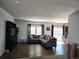 Spacious living room featuring hardwood floors, neutral decor, and great natural light at 15460 Casler Ave, Fort Lupton, CO 80136