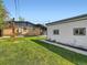 Spacious backyard featuring lush green grass and the home's exterior in the background at 170 W Midway Blvd, Broomfield, CO 80020