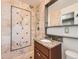 Bathroom featuring patterned tile, shower, and vanity at 170 W Midway Blvd, Broomfield, CO 80020