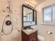 Bathroom featuring patterned tile, shower, and vanity at 170 W Midway Blvd, Broomfield, CO 80020