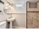 Finished basement bathroom with tiled walk-in shower, pedestal sink, and accent lighting at 170 W Midway Blvd, Broomfield, CO 80020