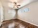 Bedroom featuring wood floors, two windows, and a ceiling fan with light at 170 W Midway Blvd, Broomfield, CO 80020