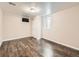 Finished basement bedroom showcasing hardwood floors, double door closet, and a window providing natural light at 170 W Midway Blvd, Broomfield, CO 80020