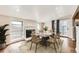 Bright dining room with fireplace, seating for six, and outdoor access at 170 W Midway Blvd, Broomfield, CO 80020