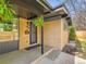 Home featuring a quaint brick entryway with a black screen door and hanging plants at 170 W Midway Blvd, Broomfield, CO 80020